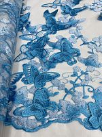 Ткань на белой сетке расшитой голубыми бабочками